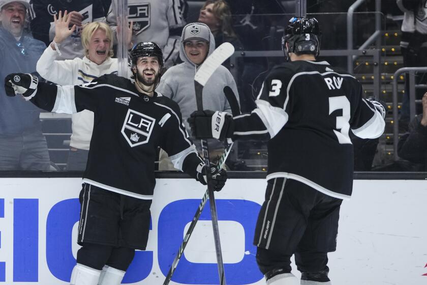 Los Angeles Kings center Phillip Danault celebrates his goal with defenseman Matt Roy.