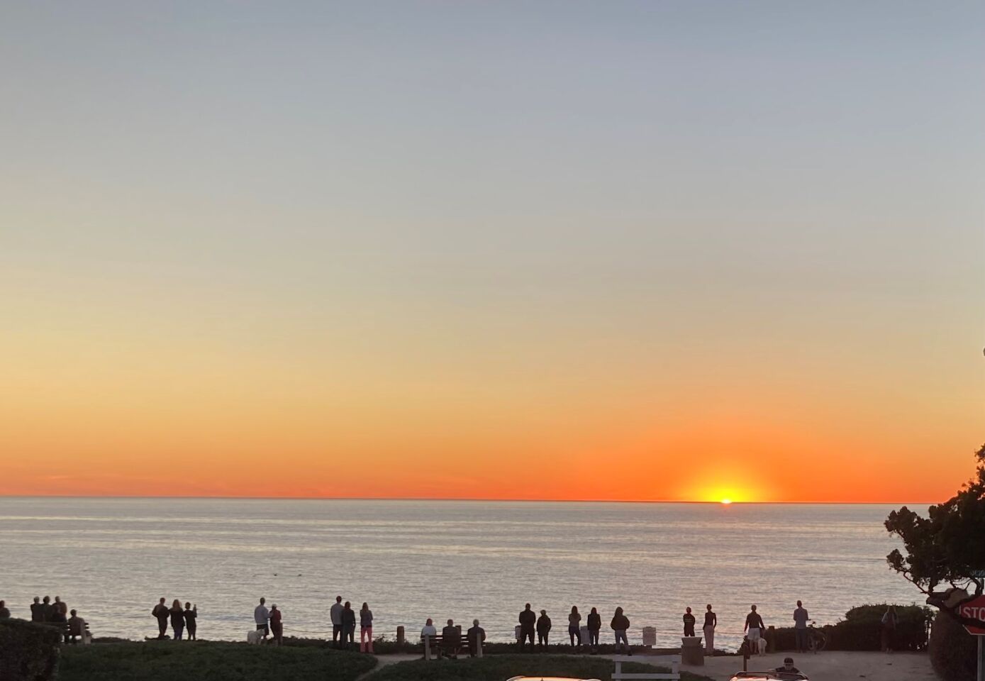 Onlookers at Windansea Beach are treated to a glowing sunset.