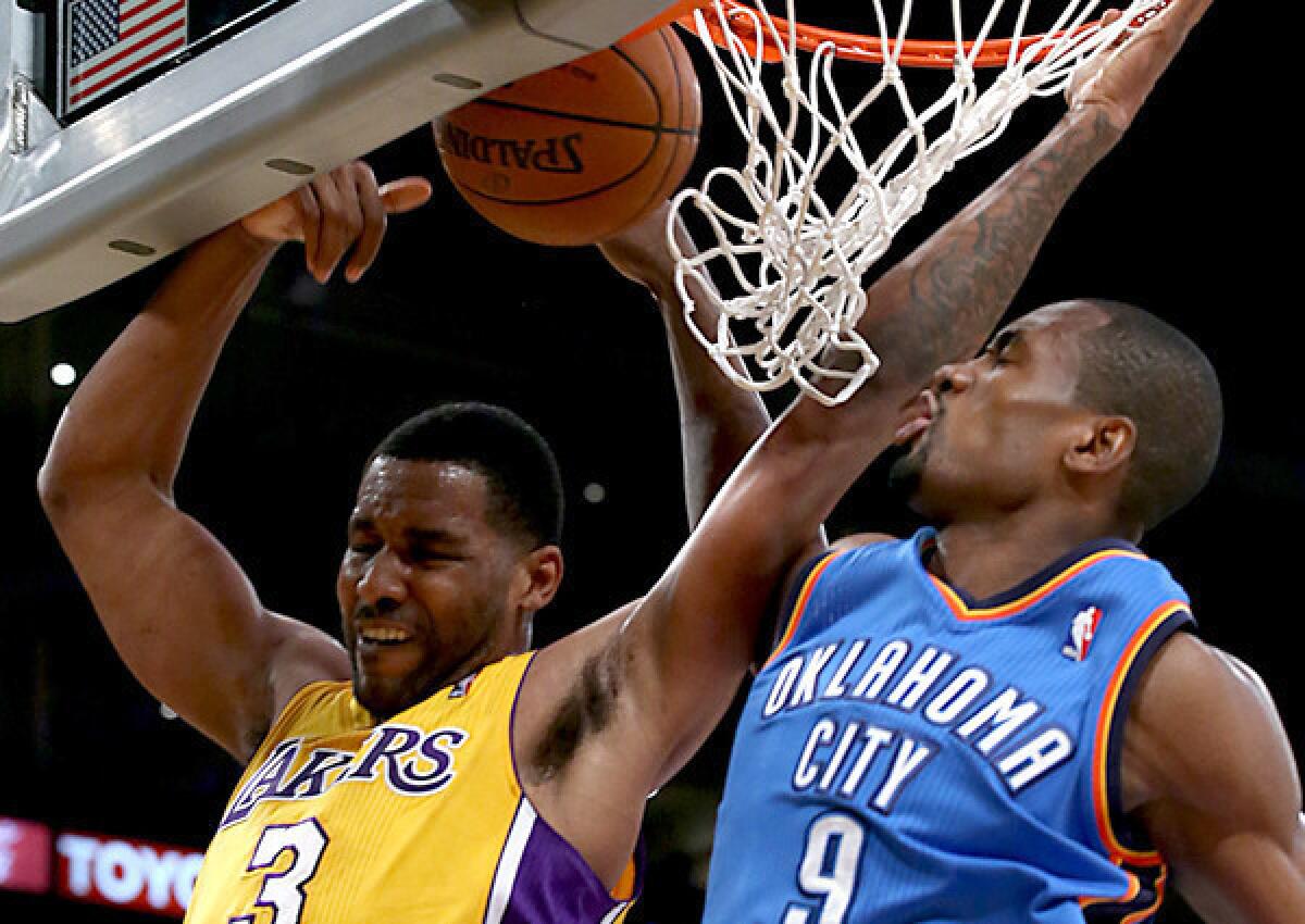 Thunder power forward Serge Ibaka blocks a shot by Lakers forward Shawne Williams in the first half Thursday night at Staples Center.