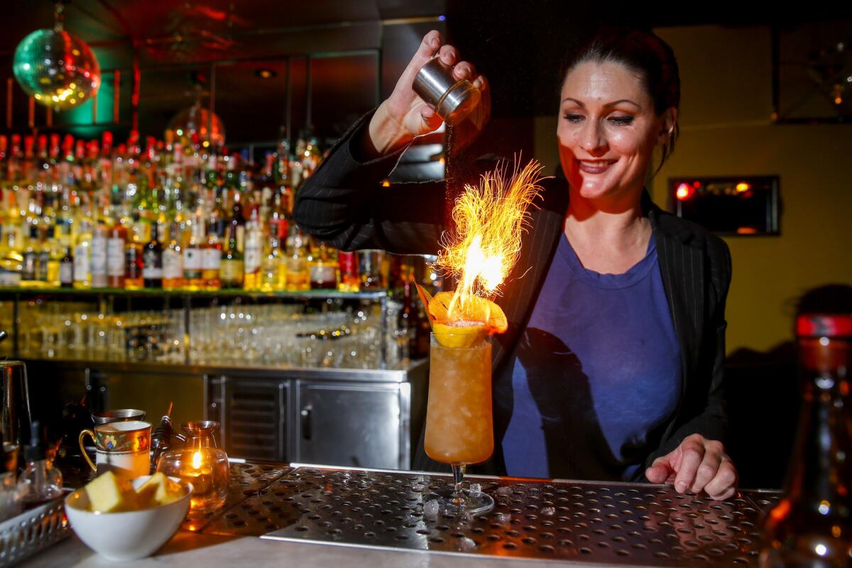 The Fiscal Agent bar director, Kristina Howald, puts the final touches on a Federal Preserves (Fire) drink, with lemon juice, allspice, cured nectarines, pineapple syrup, Amontillado sherry, gin and cinnamon.