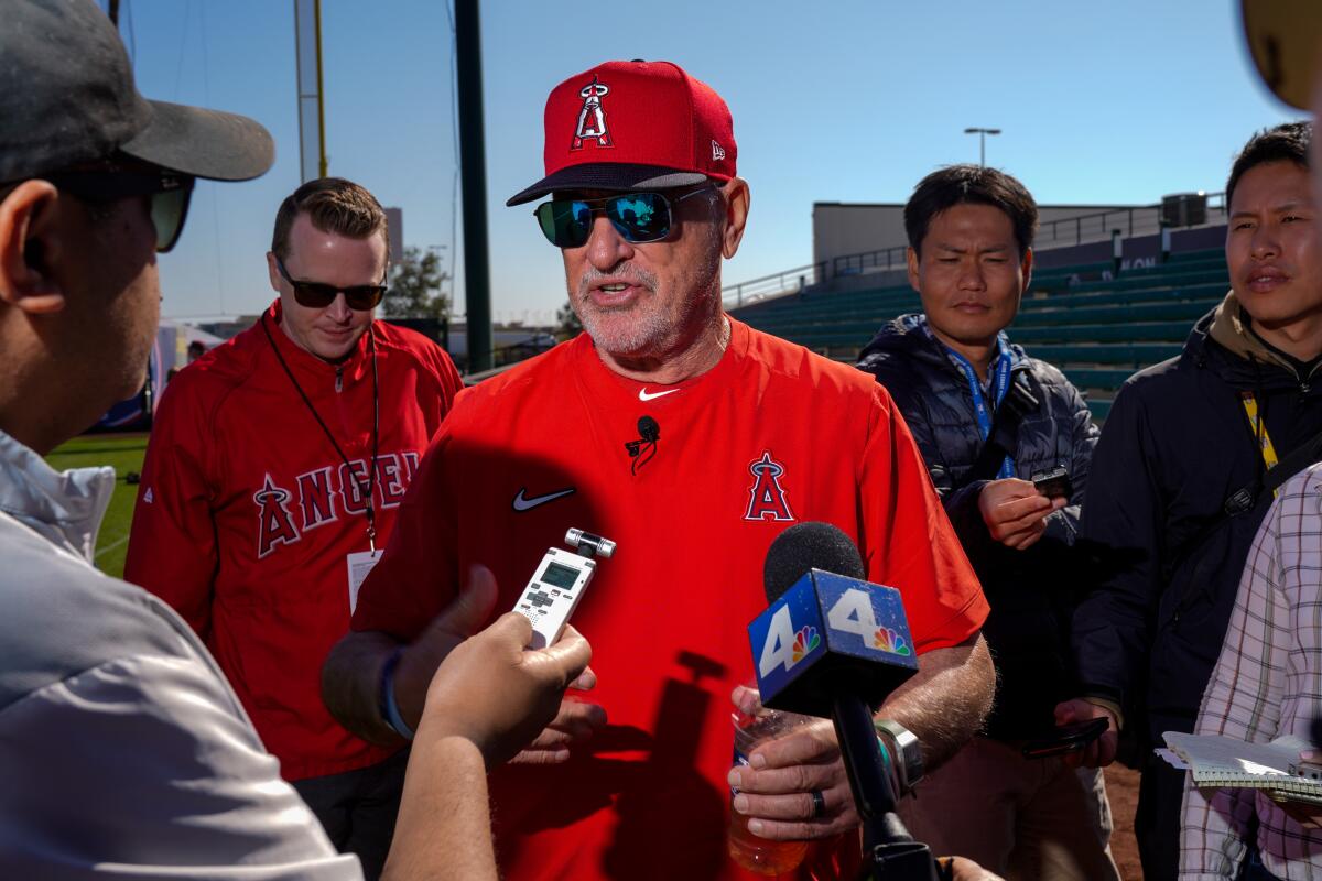 Angels manager Joe Maddon speaks with reporters before a spring training practice in Tempe, Ariz., in February 2020.