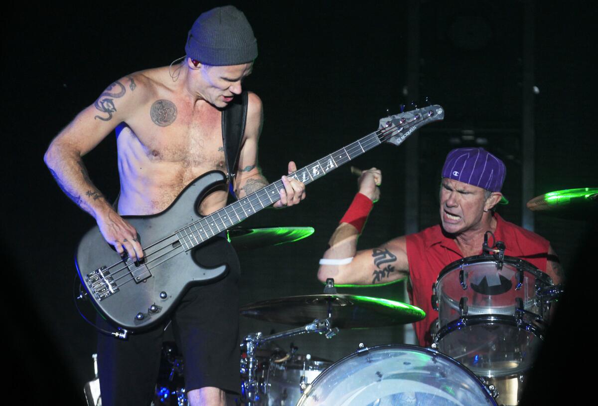 Flea and Chad Smith of the Red Hot Chili Peppers perform at the 2013 Coachella Valley Music and Arts Festival in Indio, Calif.