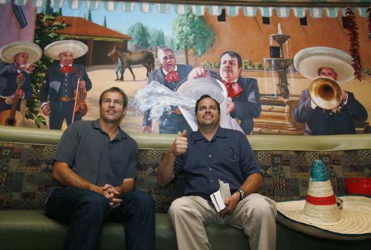 Happy with the work, artist Evan Wilson and restaurant owner Bent Hansen smile for family and friends who were at Los Gringos Locos restaurant in La Canada Flintridge for the unveiling of the mural by Evan Wilson.