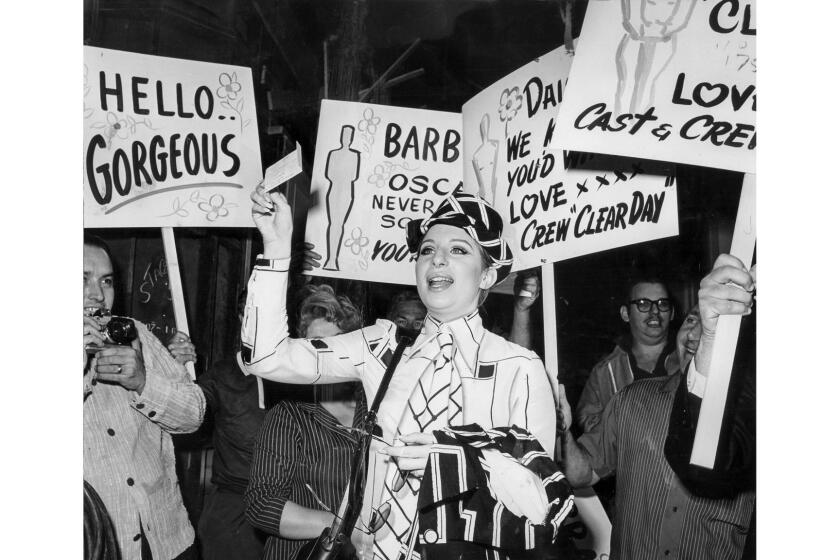 April 15, 1969: Workers at Paramount Studio greet Barbra StreisandÂ with congratulatory signs as she reports to work on set of On A Clear Day You Can See Forever. The previous night Streisand received an Oscar for her work in the movie Funny Girl. This photo was published in the April 16, 1969 Los Angeles Times.