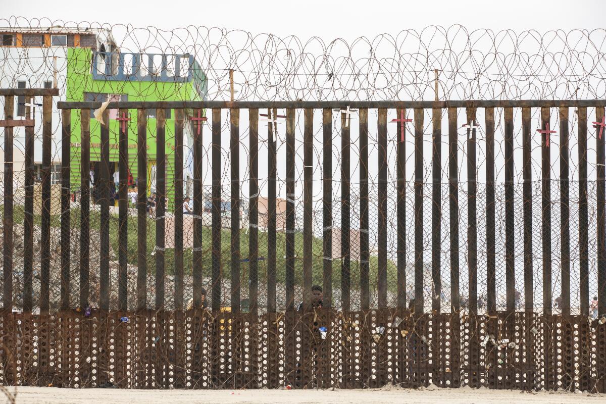 A man at a border wall.