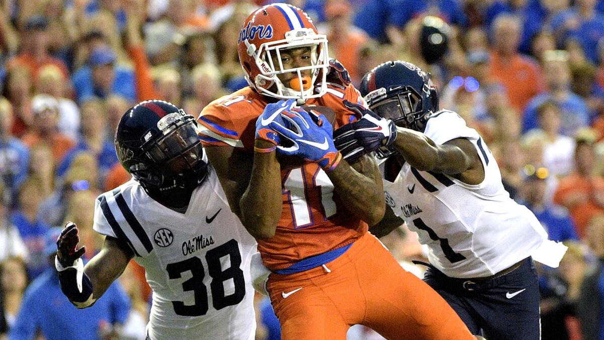 Florida receiver Demarcus Robinson (11) catches a 36-yard touchdown pass between Mississippi defensive backs Mike Hilton (38) and Tony Bridges (1) during the first half Saturday.