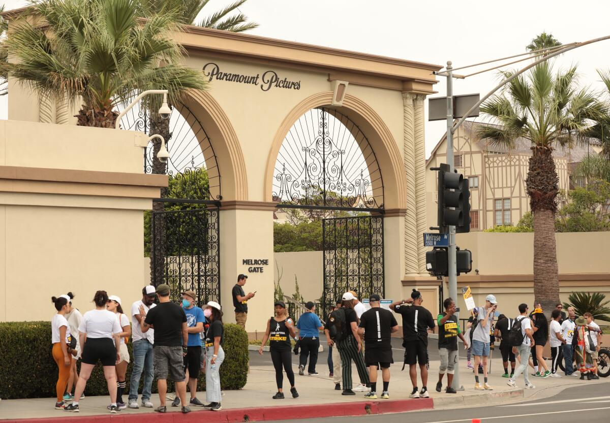 A small crowd outside the gate of Paramount Pictures