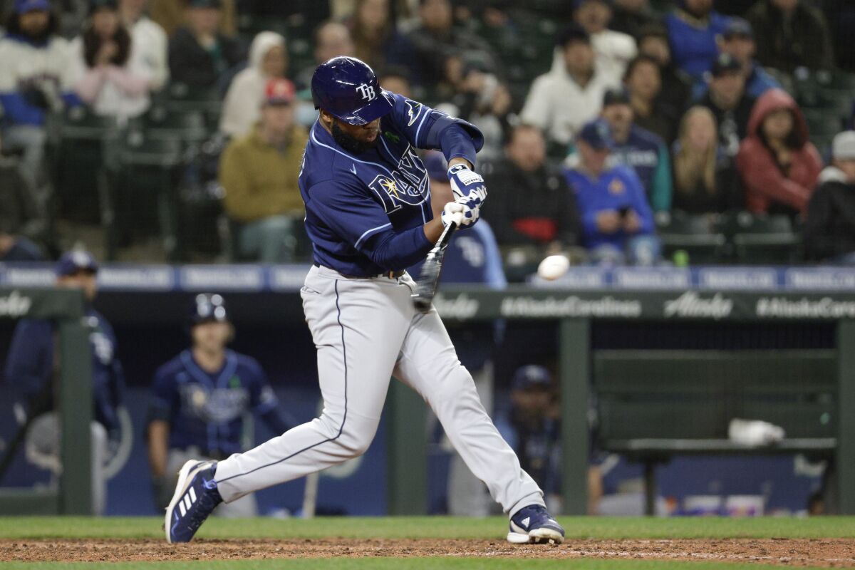 Tampa Bay Rays' Manuel Margot hits a three-run home run in the ninth inning of a baseball game against the Seattle Mariners, Friday, May 6, 2022, in Seattle. The Rays won 8-7. (AP Photo/Jason Redmond)