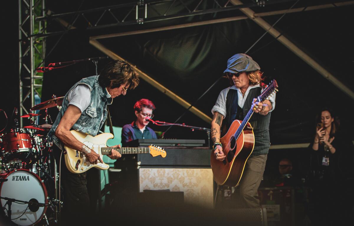 Guitar great Jeff Beck (left) and actor Johnny Depp (wearing cap)