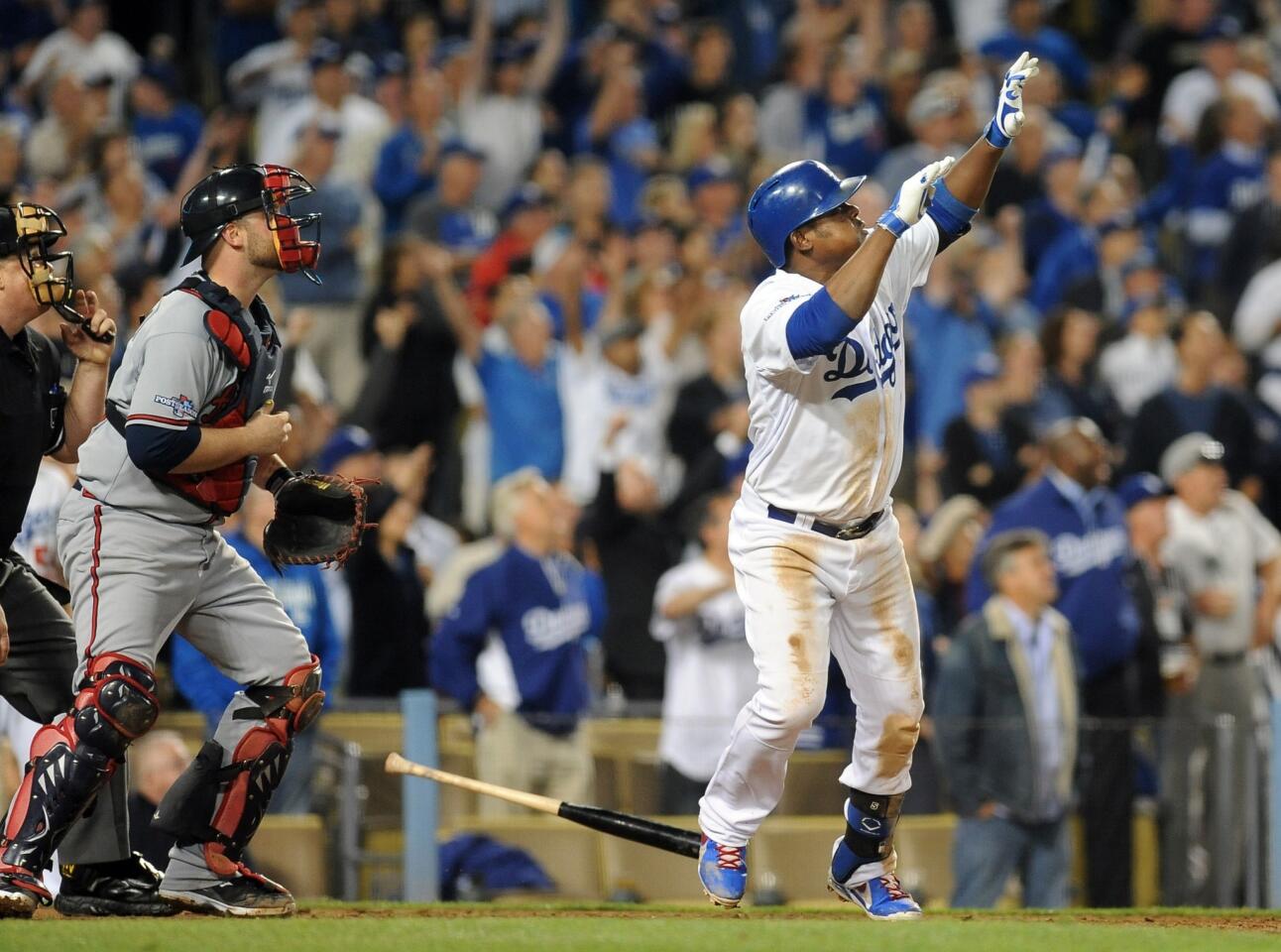 Dodgers third baseman Juan Uribe hits a two-run home run in the eighth inning to help lift the Dodgers to a series-clinching, 4-3 win over the Atlanta Braves in Game 4 of the National League division series.