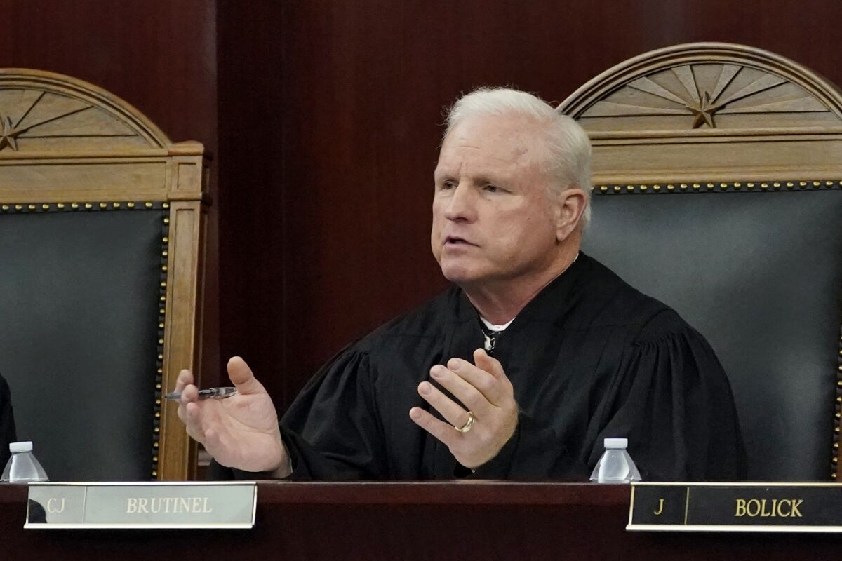 FILE - Arizona Supreme Court Chief Justice Robert M. Brutinel speaks during oral arguments, in Phoenix on April 20, 2021. Arizona victims of long-ago child sex abuse can proceed with lawsuits against groups like the Boy Scouts of America following a recent decision by the state Supreme Court that rejected claims that a 2019 state law extending victims' right to sue was unconstitutional. (AP Photo/Matt York, File)