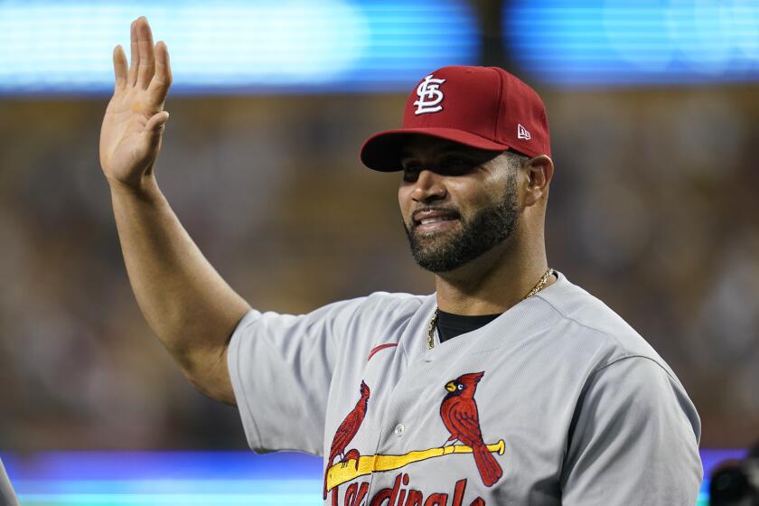 St. Louis Cardinals designated hitter Albert Pujols greets fans as he is honored.