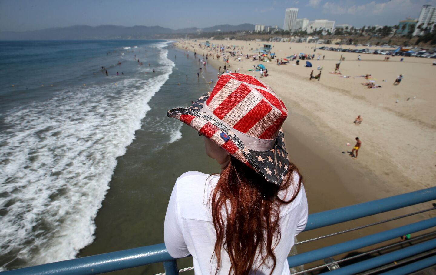 Crissie Sumerlin, a visitor from Baltimore, takes in the view and the cool breeze at Santa Monica Pier as a heat wave continues to bake Southern California.