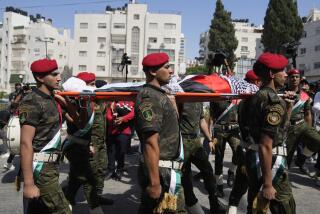 A Palestinian honor guard carries the body of Aysenur Ezgi Eygi, 26, who was fatally shot by Israeli soldiers while participating in an anti-settlement protest in the West Bank, during her funeral procession in the West Bank city of Nablus, Monday, Sept. 9, 2024. (AP Photo/Nasser Nasser)