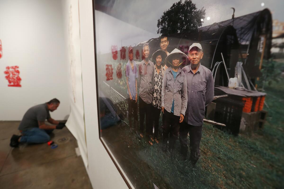 A photograph by Binh Dahn shows a Vietnamese family on a farm in New Orleans.