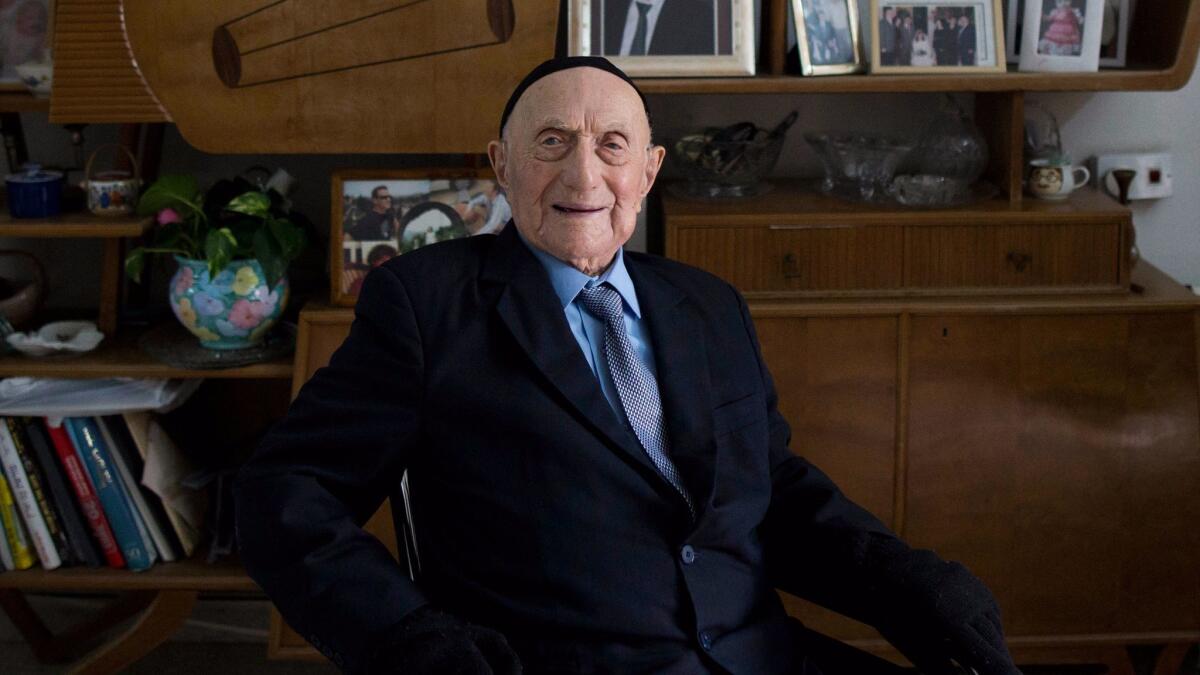 Holocaust survivor Israel Kristal poses for a photograph at his home in the city of Haifa, Israel.