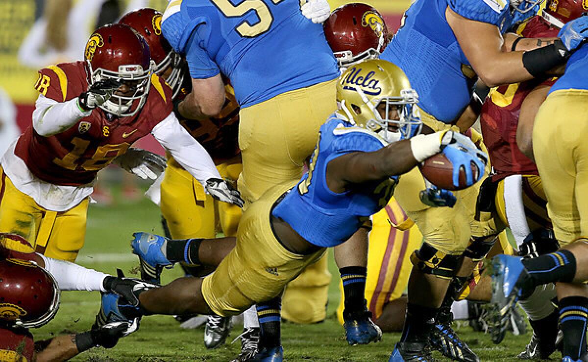 UCLA running back Myles Jack dives into the end zone for a touchdown during the Bruins' 35-14 win over USC on Nov. 30. Assuming linebacker and running back roles for the Bruins has made Jack a star -- at least in the Bruins' locker room and on the UCLA campus.