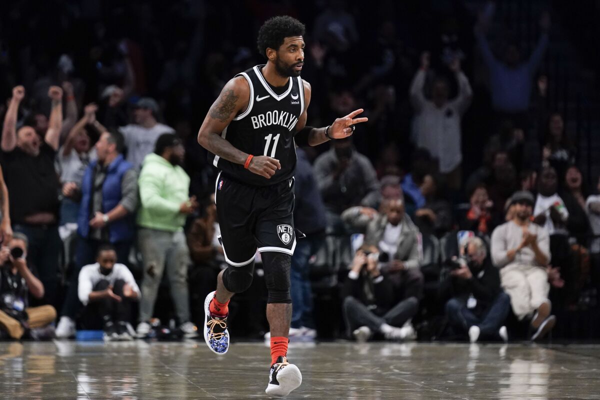 Brooklyn Nets' Kyrie Irving reacts after hitting a basket against the Cleveland Cavaliers.