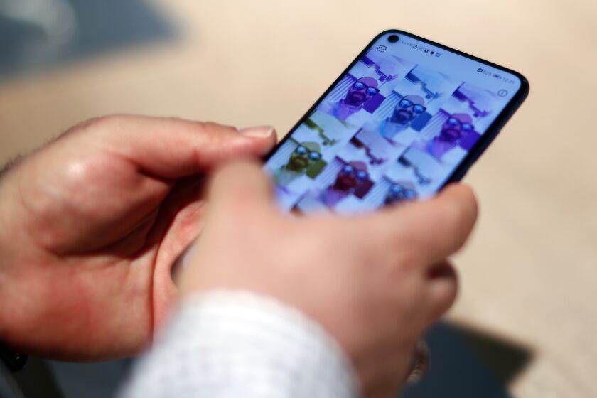 A visitor holds the new Samsung Galaxy S10 5G during the Mobile World Congress wireless show, in Barcelona, Spain, Monday, Feb. 25, 2019. The annual Mobile World Congress (MWC) runs from 25-28 February in Barcelona, where companies from all over the world gather to share new products. (AP Photo/Manu Fernandez)