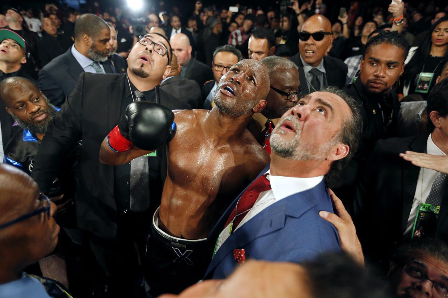 Bernard Hopkins looks at the overhead monitor to watch the replay, after being knocked out of the ring during the eighth round of his fight with Joe Smith Jr. on Dec. 17.