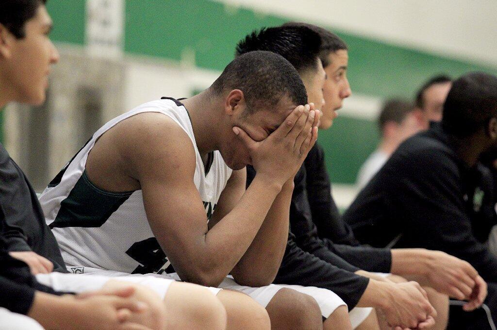 Costa Mesa High's Oronde Crenshaw buries his face in his hands in the final minutes of a CIF-Southern Section Division 4AA first-round game against Harvard-Westlake on Wednesday.