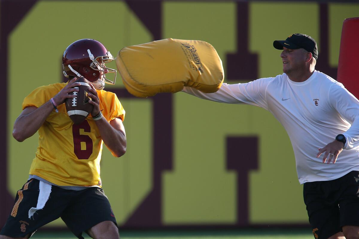Clay Helton, right, works with USC quarterback Cody Kessler in August.