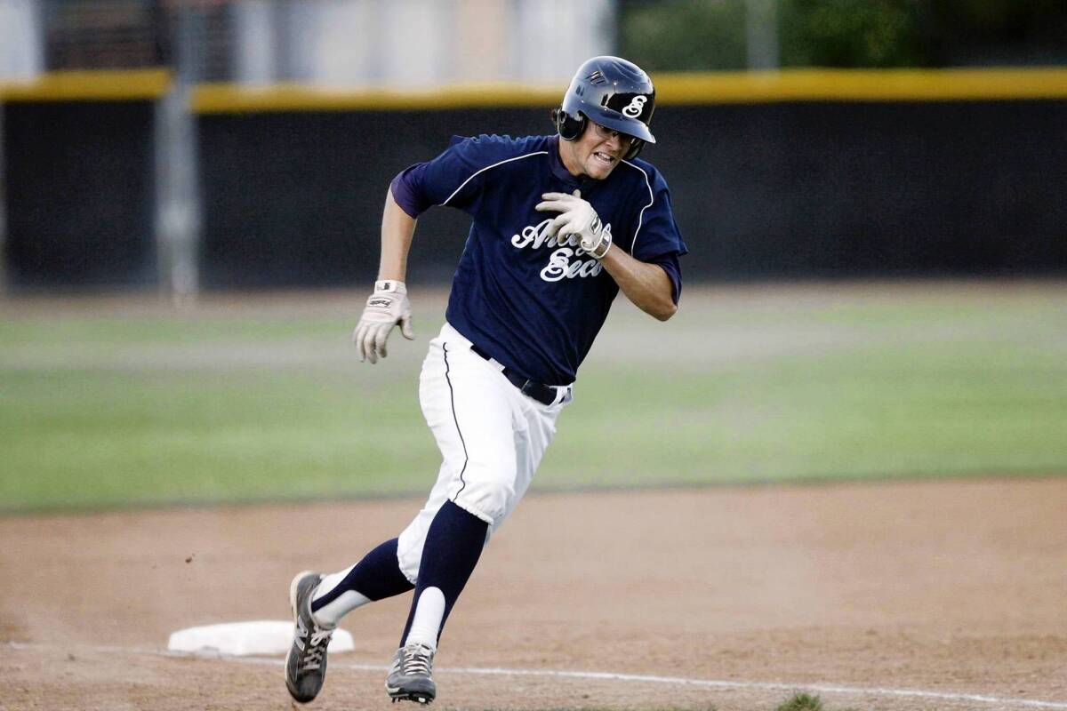 Elliot Surrey scores a run for the Arroyo Seco Saints during Tuesday's game against the Arcadia Astros at Jackie Robinson Field.