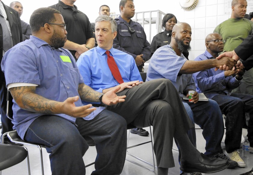 U.S. Education Secretary Arne Duncan, second from left, speaks with inmates participating in the Goucher College Prison Education Partnership in Maryland.