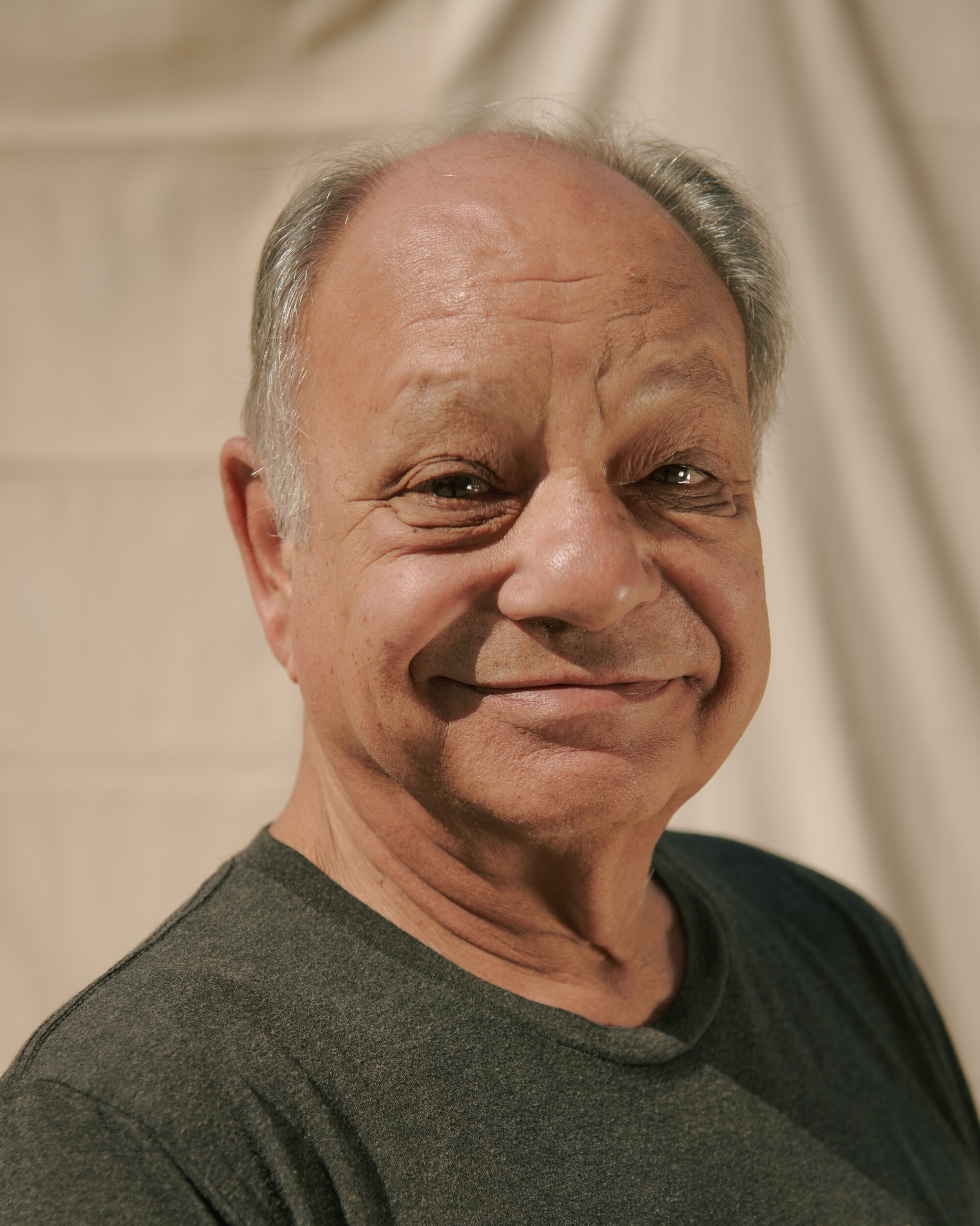 A close-up portrait of a smiling Cheech Marin.