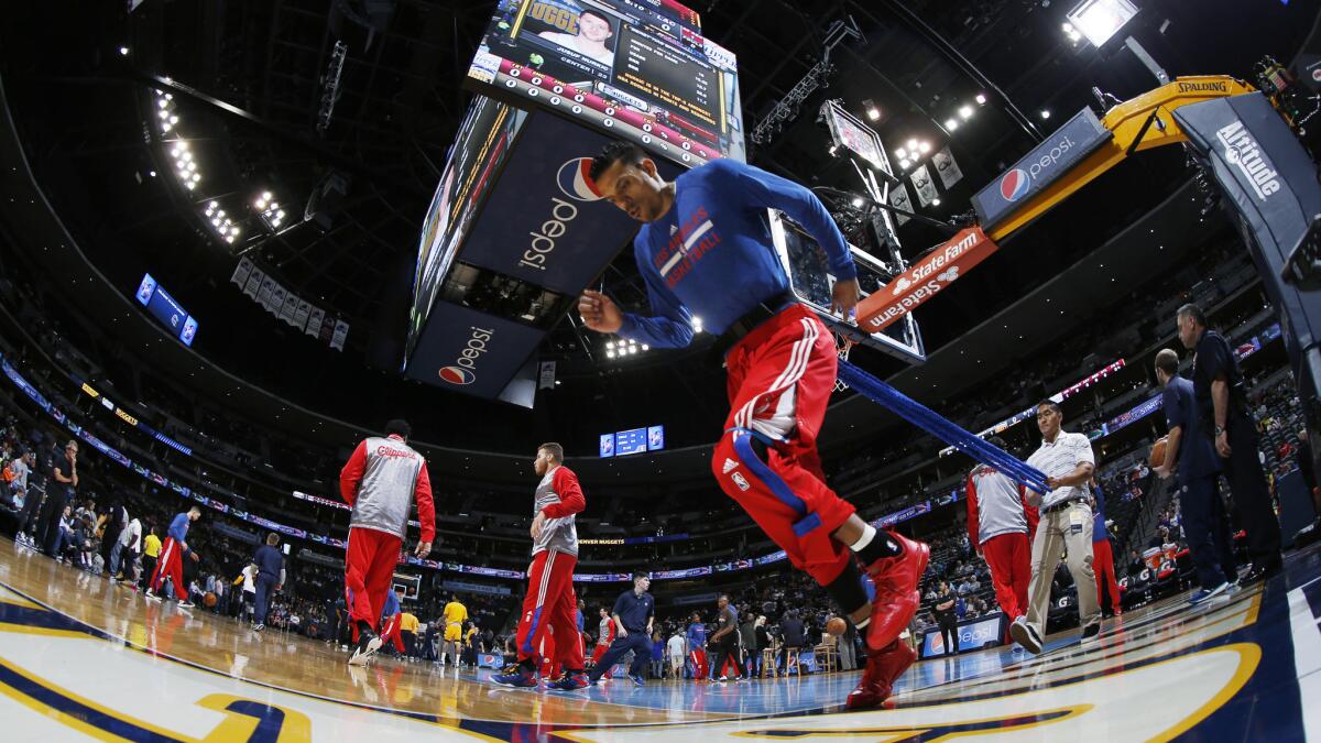 Clippers small forward Matt Barnes warms up by running with a resistance band around his waist before a win over the Denver Nuggets on Saturday.