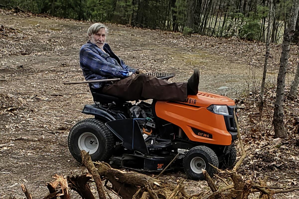 Man atop a lawnmower
