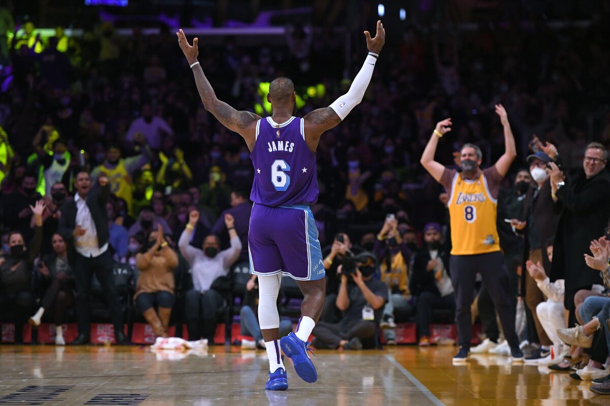 Los Angeles Lakers forward LeBron James (6) motions to the crowd during the first half of the team's NBA basketball game against the Portland Trail Blazers, Friday Dec. 31, 2021, in Los Angeles. (AP Photo/John McCoy)