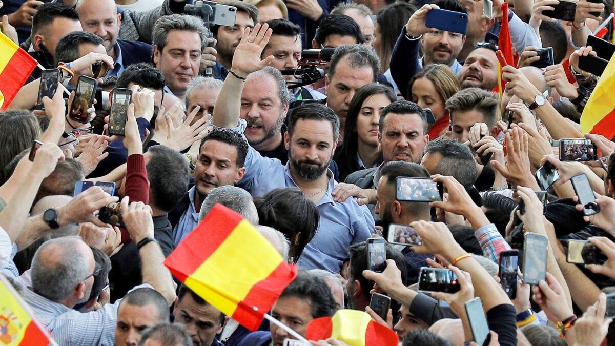 Santiago Abascal, center, of the Spanish far-right party Vox waves to his supporters during an election event Thursday in Valencia.