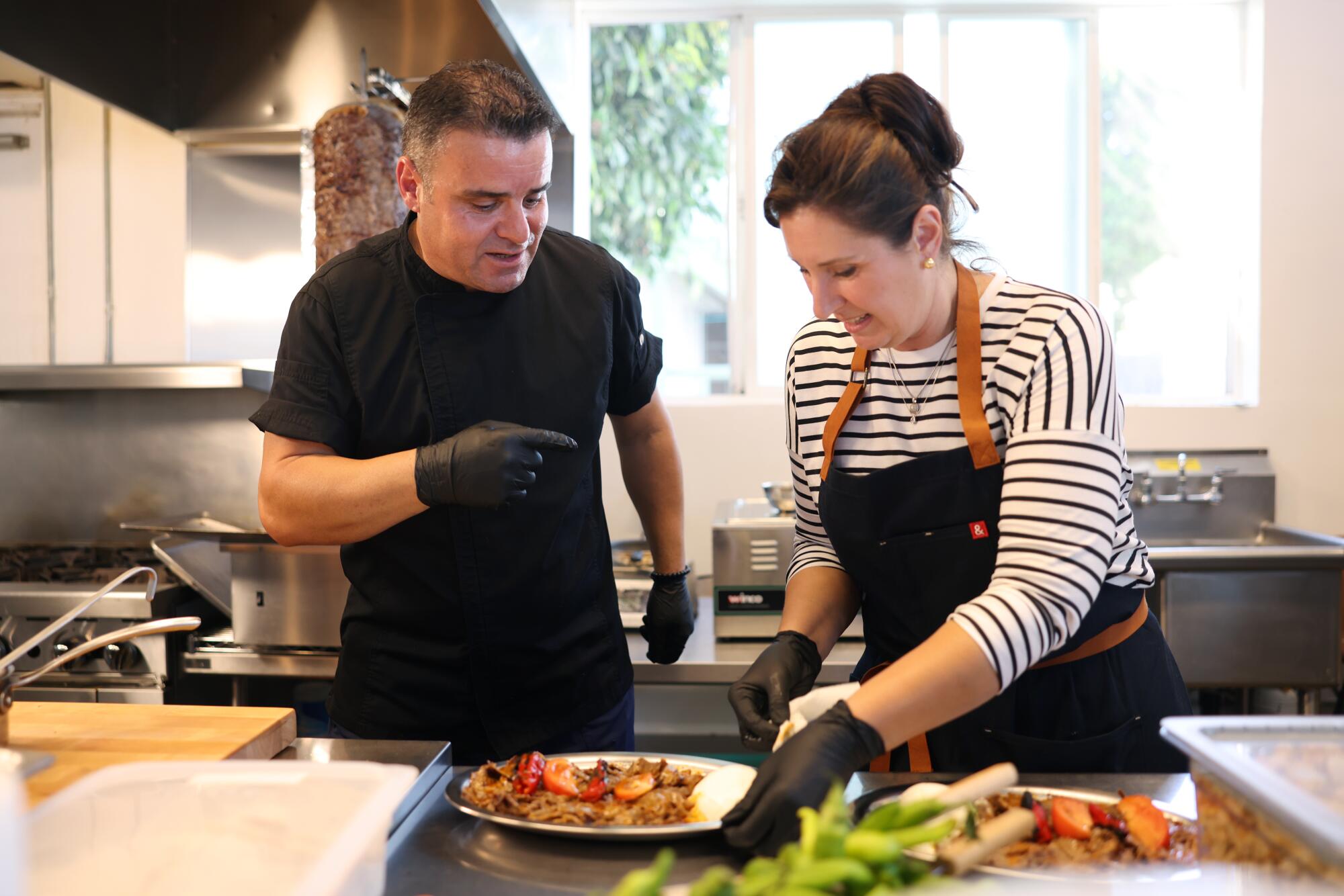 Senem Sanli prepares dishes with Husnu Kahramanoglu.