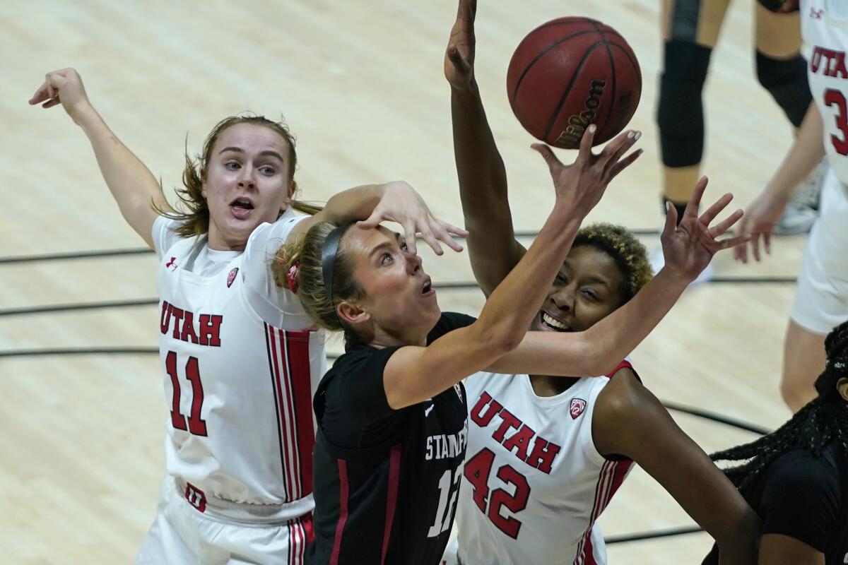 Utah's Brynna Maxwell (11) and Peyton McFarland (42) defend against Stanford guard Lexie Hull (12) in the first half during an NCAA college basketball game Friday, Jan. 15, 2021, in Salt Lake City. (AP Photo/Rick Bowmer)
