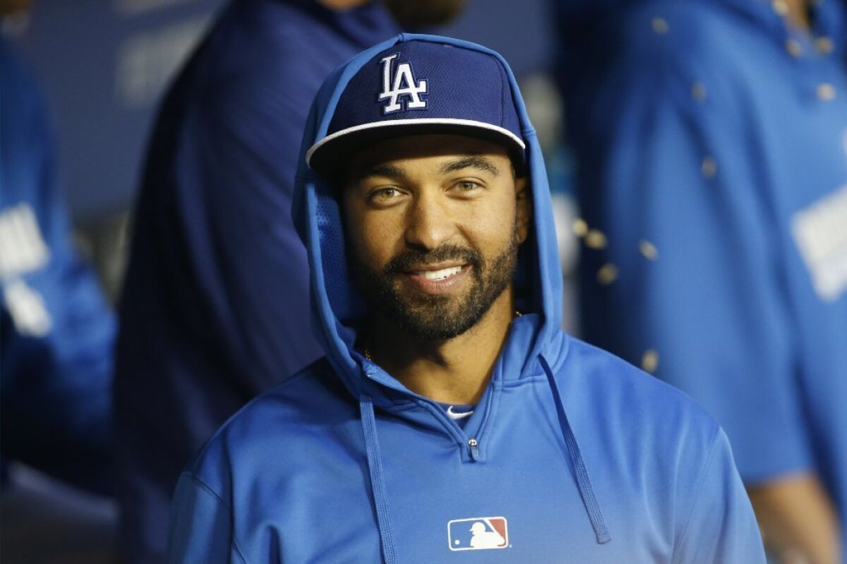 Dodgers' Matt Kemp smiles in the dugout before an exhibition against the Angels on March 28.