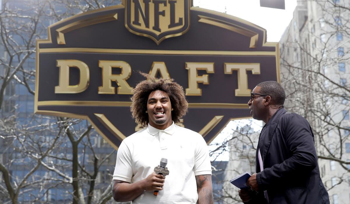 Former USC defensive lineman Leonard Williams is interviewed by former NFL star and ESPN analyst Cris Carter during a pre-draft rally in Chicago on Wednesday.