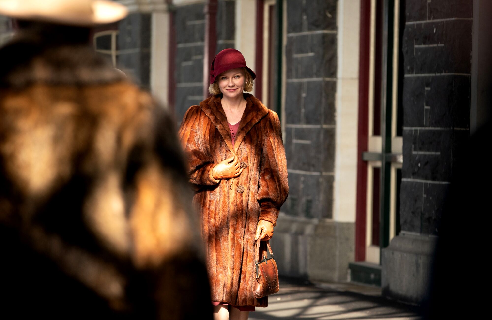 A woman in a red hat and a fur coat.