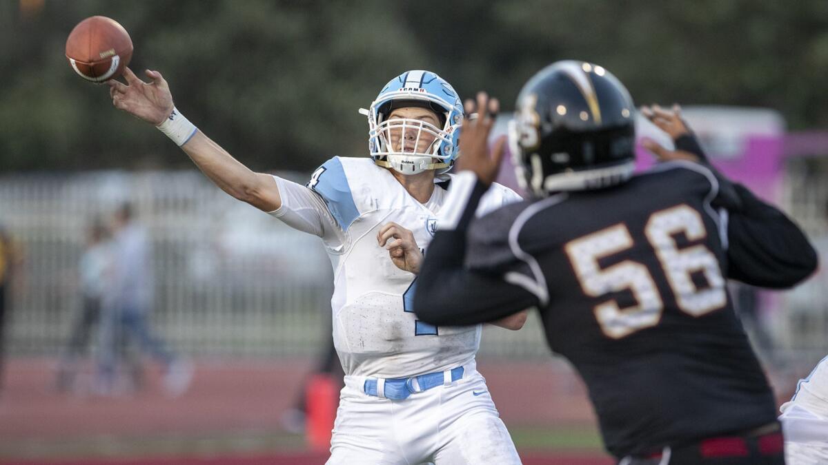 Corona del Mar High junior quarterback Ethan Garbers, shown under pressure during a 49-7 loss to JSerra on Aug. 17, threw for 146 yards in the season opener.