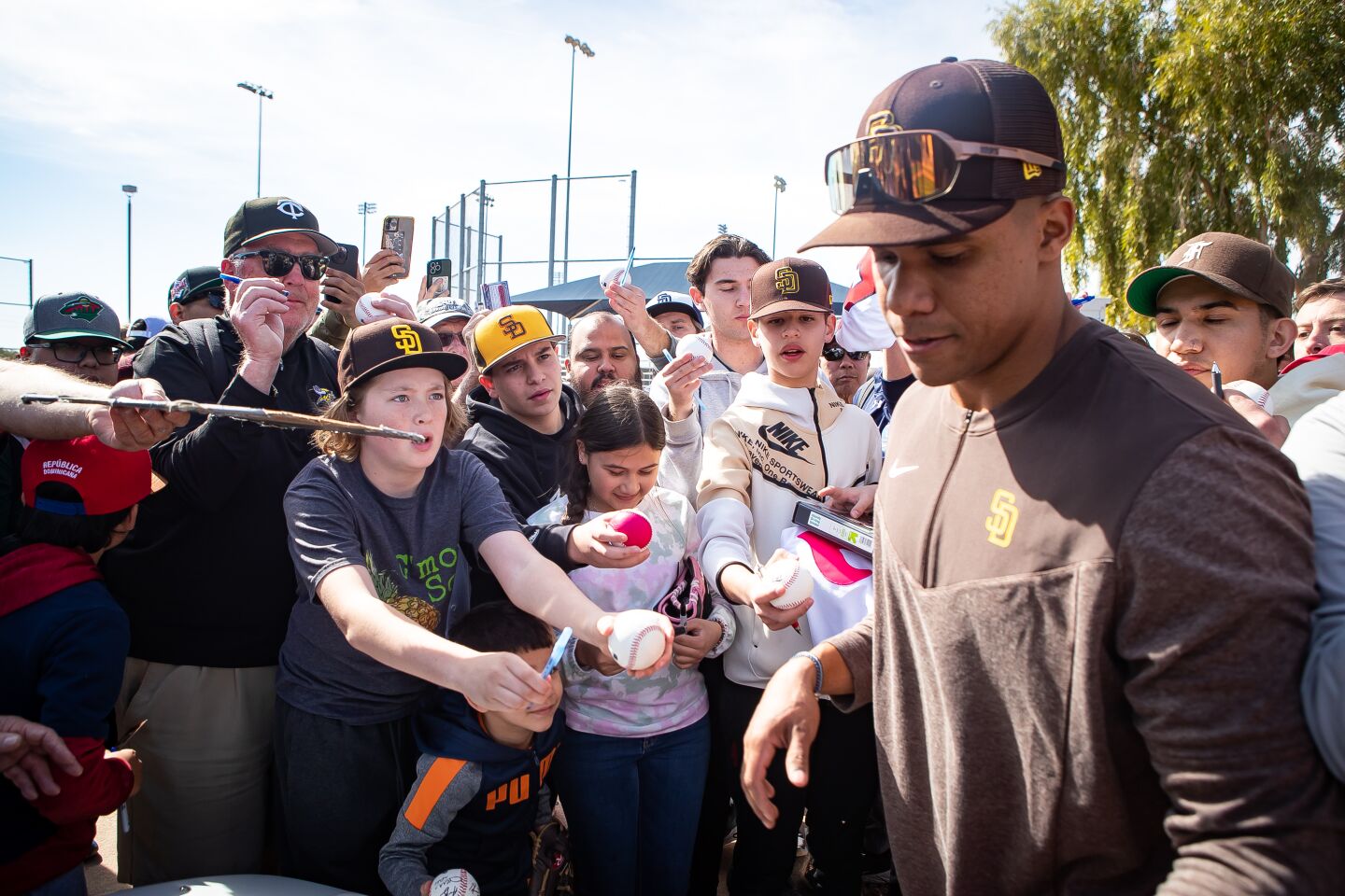 Fans beg Padres right fielder Juan Soto for autographs during a spring training practice at the Peoria Sports Complex.
