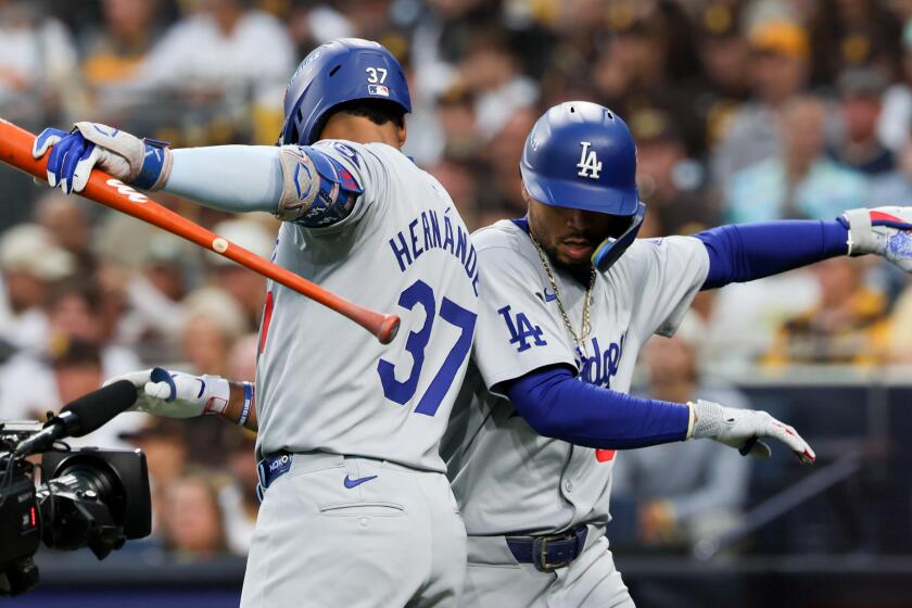 Dodgers Mookie Betts celebrates with Teoscar Hernandez after hitting a solo home run during Game 4