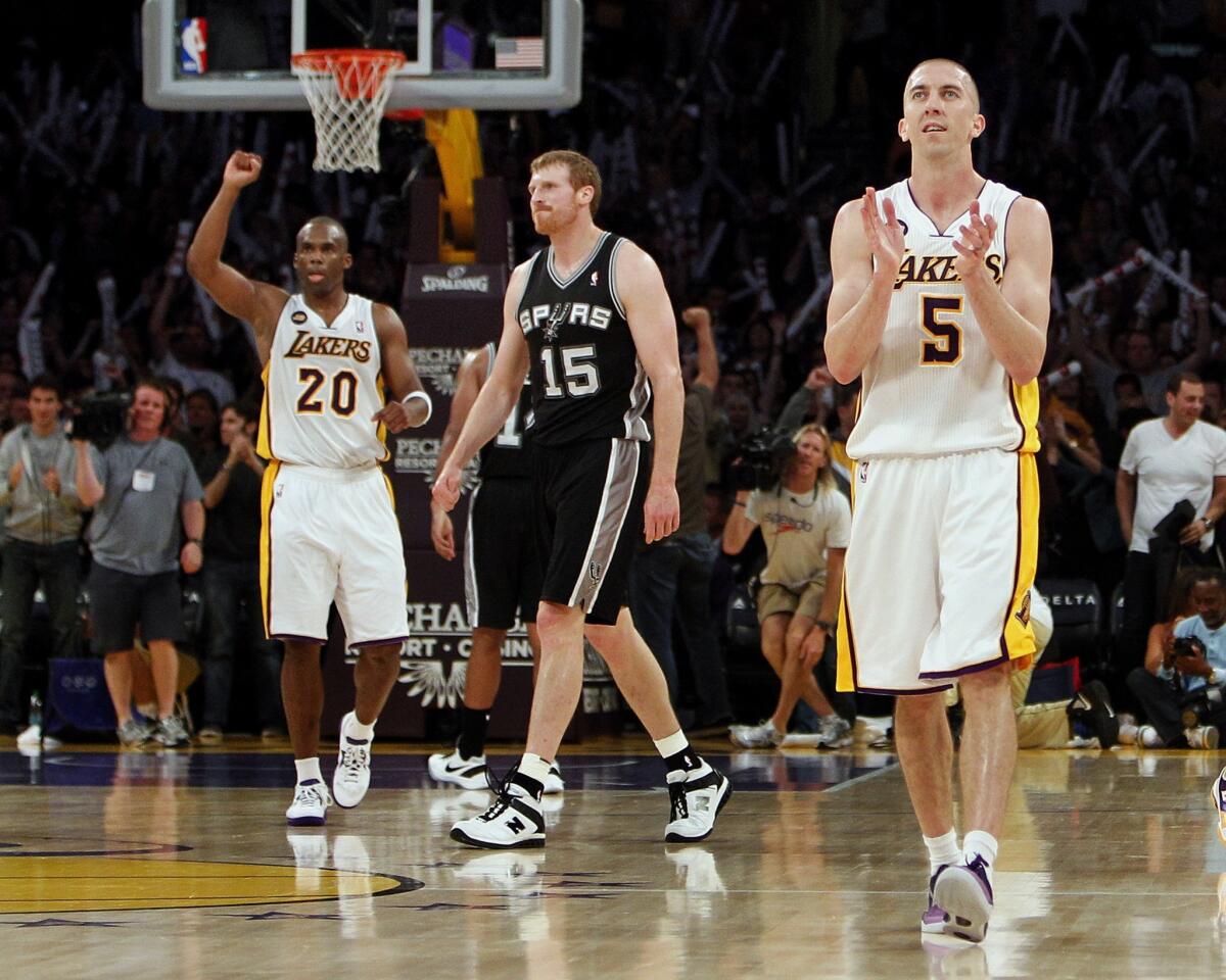 Lakers point guard Steve Blake (5), who finished wiht 23 points, and guard Jodie Meeks (20) begin to celebrate in the final seconds of a 91-86 victory over the San Antonio Spurs on Sunday night at Staples Center.