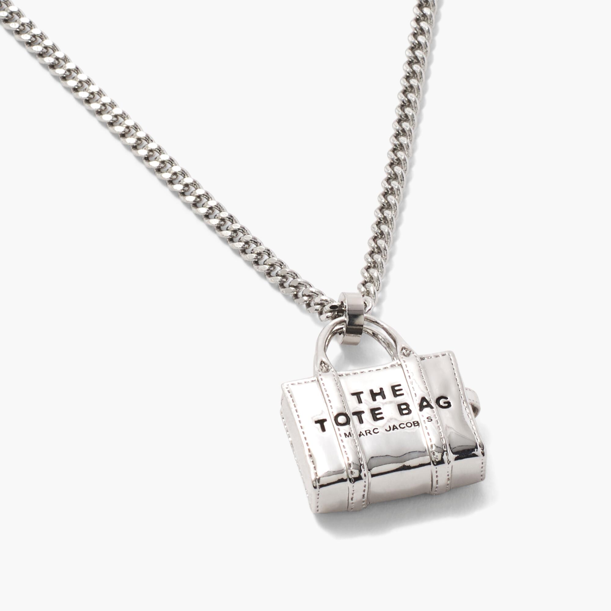 The Marc Jacobs Tote Bag Necklace featuring a mini silver bag and a chain.
