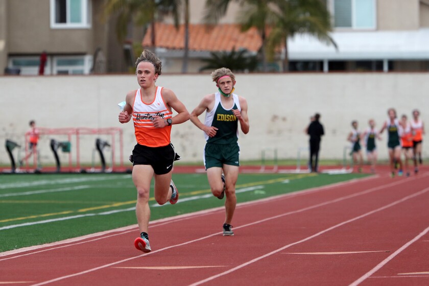 Huntington Beach's Nolan Walt, left, competes against Edison's Wylie Cleugh, right, on Saturday, Feb. 13.