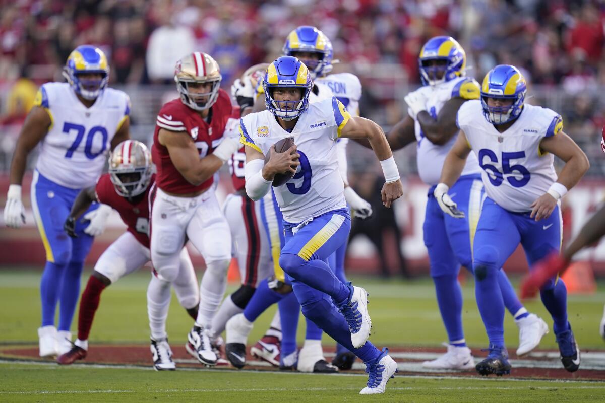 Rams quarterback Matthew Stafford (9) scrambles against the San Francisco 49ers.