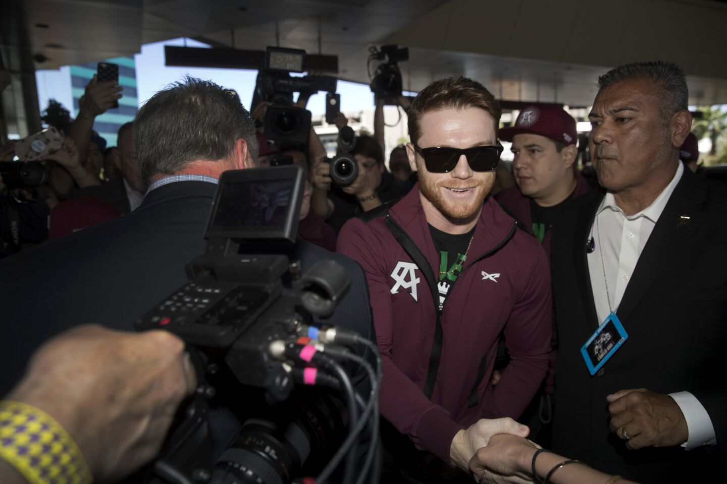 Middleweight boxer Canelo Alvarez of Mexico greets a fan as he arrives at the MGM Grand hotel-casino in Las Vegas Tuesday, Sept. 11, 2018. Alvarez will challenge WBC/WBA middleweight champion Gennady Golovkin of Kazakhstan in a rematch at T-Mobile Arena in Las Vegas on Sept. 15. (Steve Marcus/Las Vegas Sun via AP)