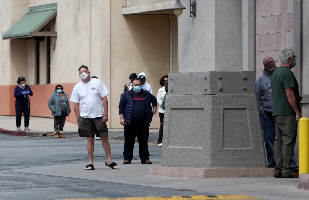 Shoppers form a line outside Ralphs grocery store on Foothill Boulevard in La Cañada Flintridge on Tuesday, April 7.