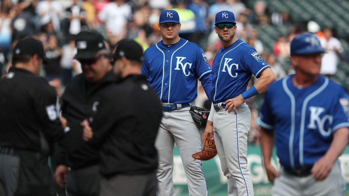 Kansas City Royals pitcher Brad Keller, left center, stands on the mound moments before being ejected for hitting Chicago White Sox shortstop Tim Anderson with a pitch.