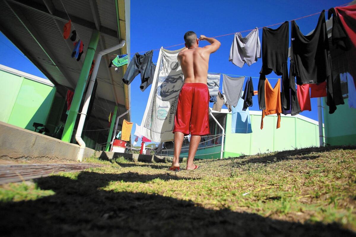 A Cuban migrant deals with laundry at a shelter in La Cruz, Costa Rica. Nearly 8,000 Cubans have found themselves waylaid in temporary shelters in Costa Rica since leaving their homeland.