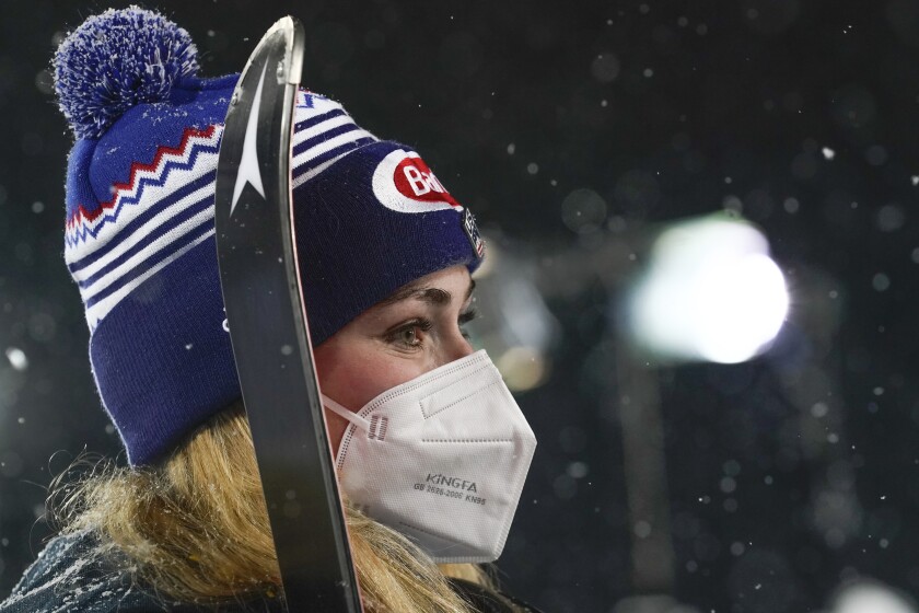 United States' Mikaela Shiffrin wears a face mask as she waits for the podium ceremony after winning an alpine ski, women's World Cup slalom in Flachau, Austria, Tuesday, Jan. 12, 2021. (AP Photo/Giovanni Auletta)